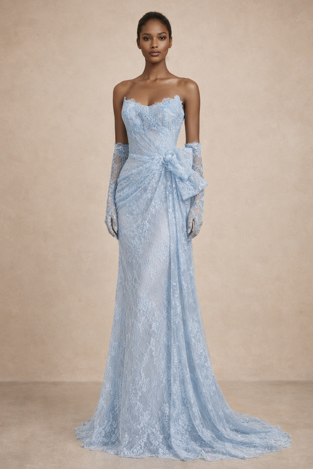 Woman wearing a light blue strapless gown with gloves against a beige background