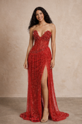 Woman wearing a red evening gown with a slit on a beige background